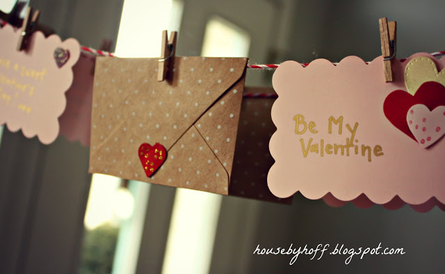 Polka dot, pink and ruffled envelopes hanging as a garland.