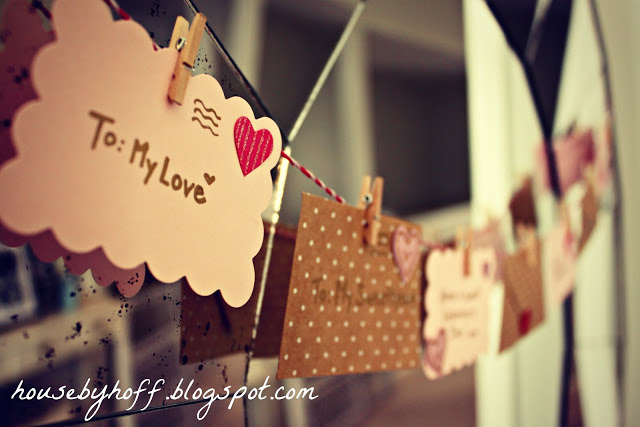 Love envelopes hanging as a garland by clothespins.