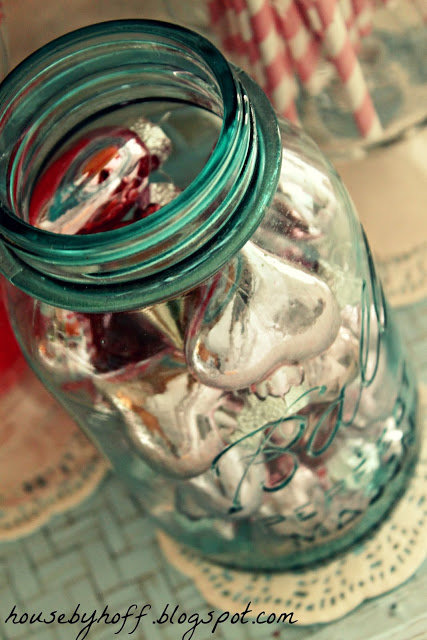 Up close picture of the soft green clear mason jar filled with hearts.