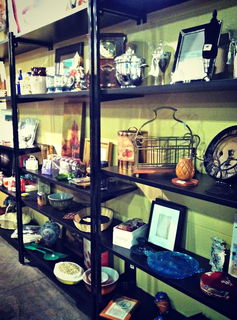 Items for sale on shelves in the vintage store.