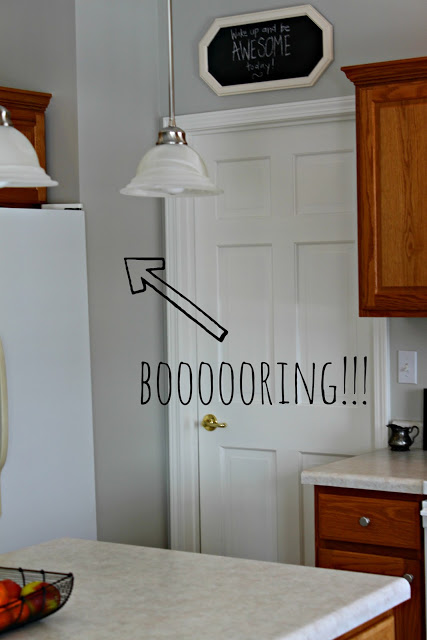 An arrow pointing to a boring plain wall in the kitchen.