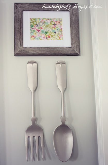 A water-colour picture with a fork and a spoon underneath it.