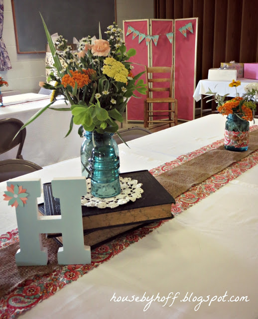 Flowers in a vase on vintage books on table.