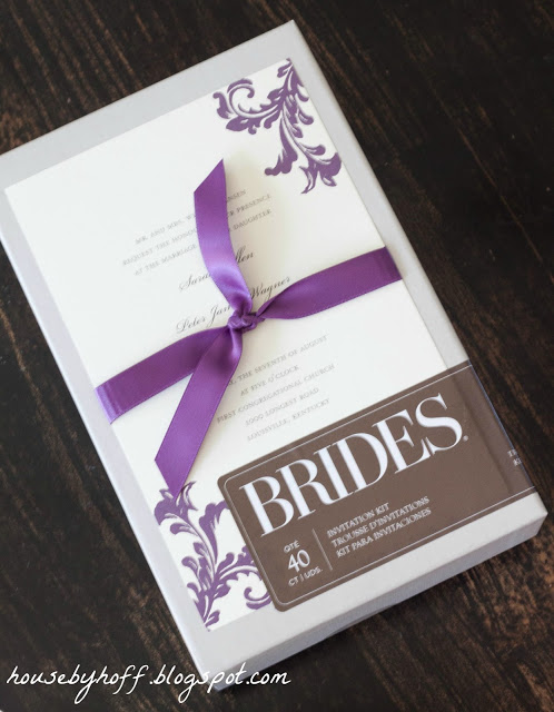 The invitation with a purple ribbon.