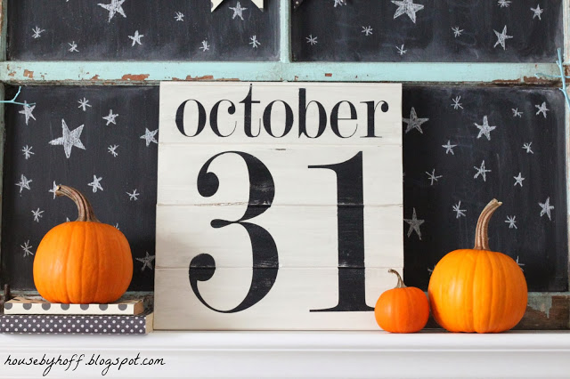 Pumpkins are beside the October 31 sign.