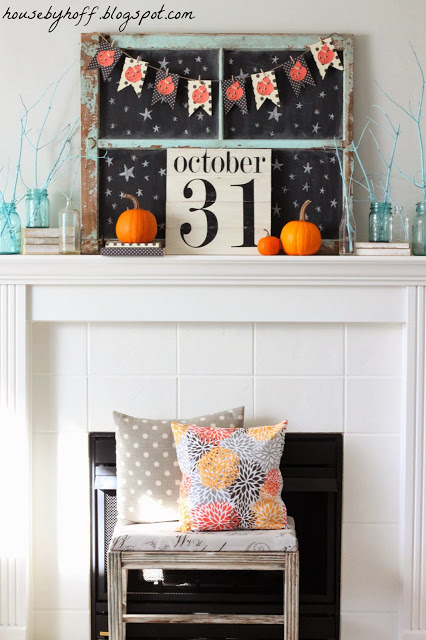 A white fireplace mantel decorated for Halloween.