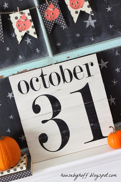 October 31, with a pumpkin garland above it and stars on a chalkboard.