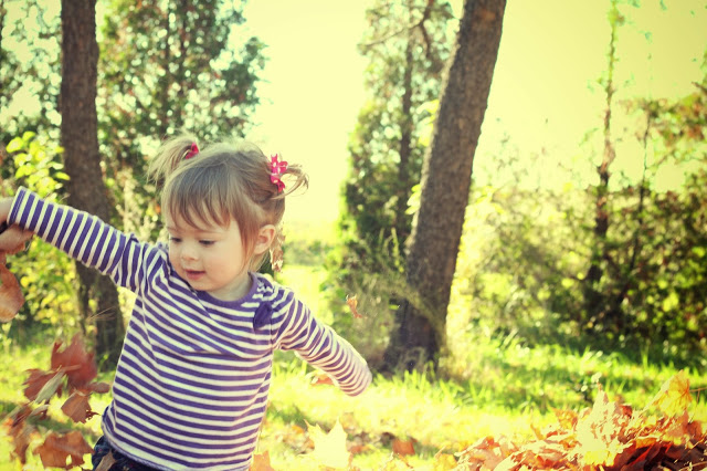 Miss L playing in the woods.