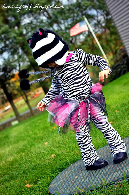 Little girl dancing in her zebra costume.