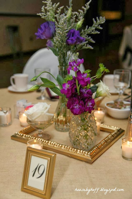 Gold picture frames with the table seat in it.