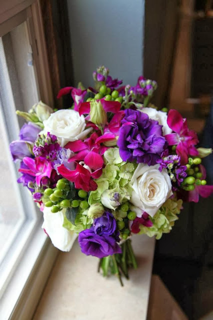 A purple, pink, white and green bouquet of fresh flowers.