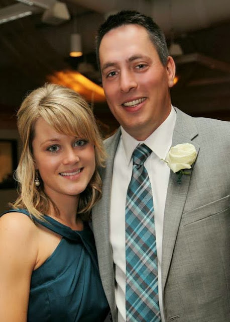 A bridesmaid and her husband posing.