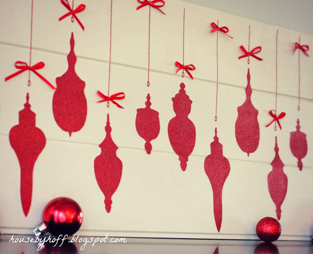 Red ornaments lying in front of the ornaments sign.