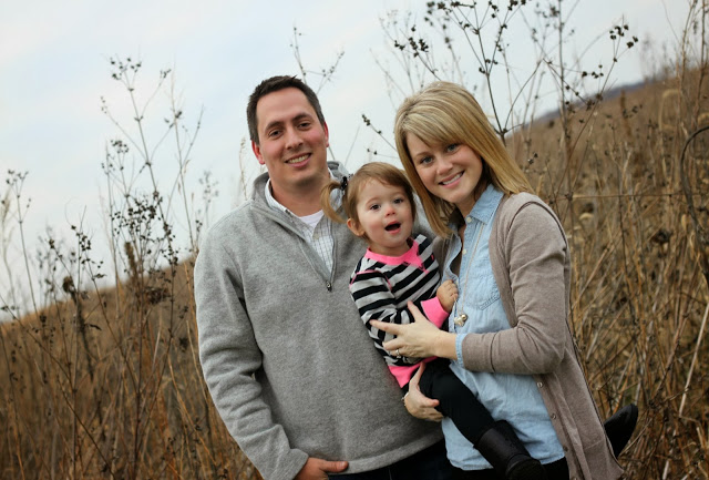 The three family members smiling.