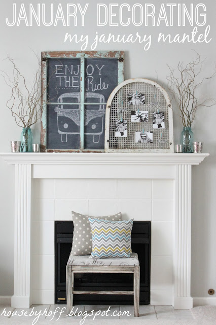 A fireplace with a bench and pillows in front of it and a chalkboard with a bus drawn on it.