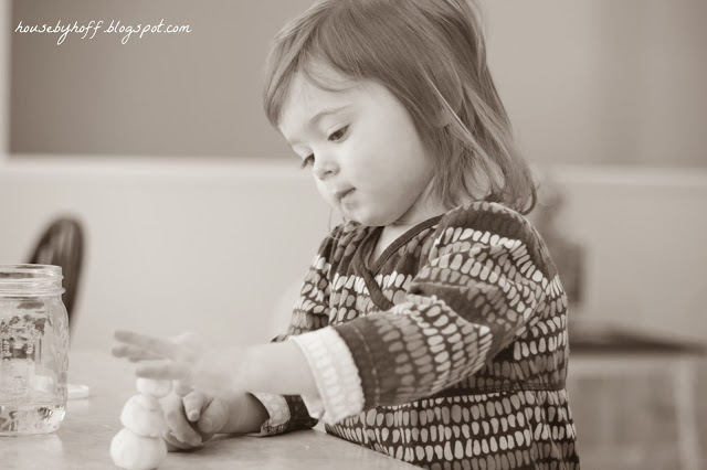 Making a snowman inside on the counter.