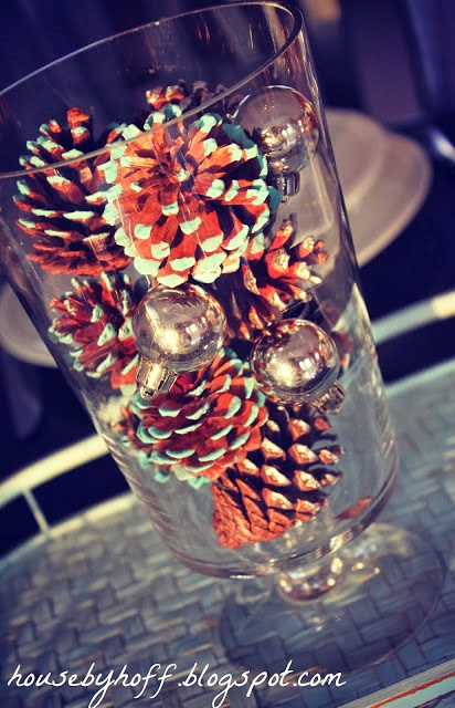 The painted pine cones in a clear glass vase.