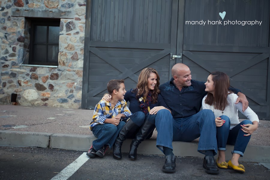 tips for family photos via housebyhoff.com A family of four in front of a barn like door.
