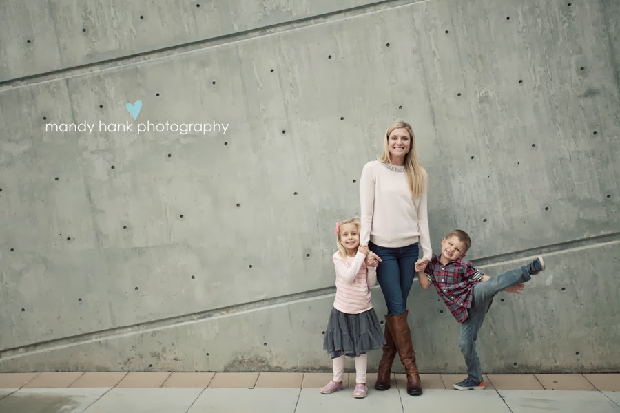 tips for family photos via housebyhoff.com Portrait of a Mom and her kids against a concrete wall.