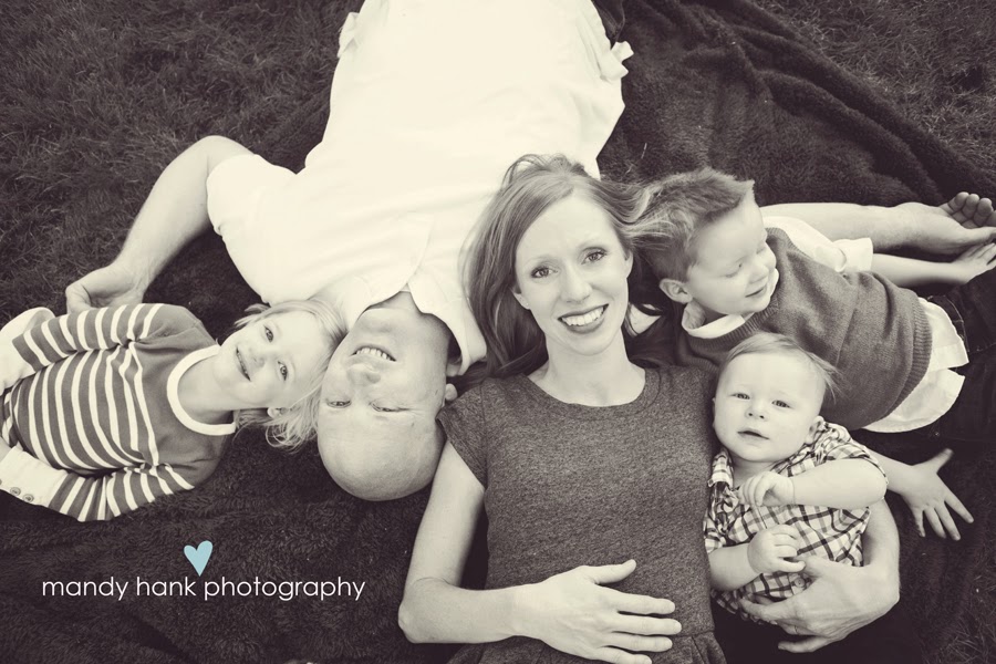 Family lying on the ground getting a picture taken.