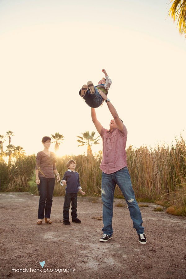 A child being tossed in the air by the Dad.