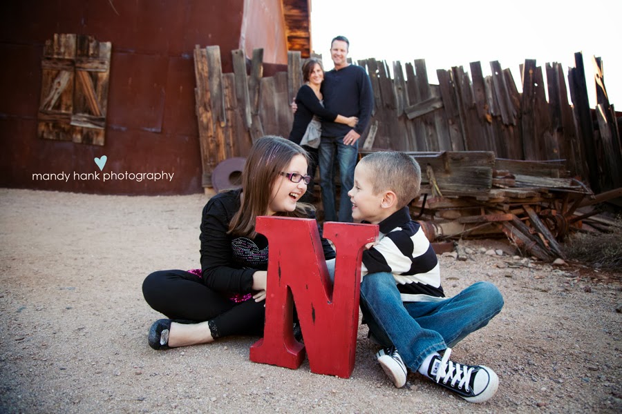 Children in front of an "N" sign.
