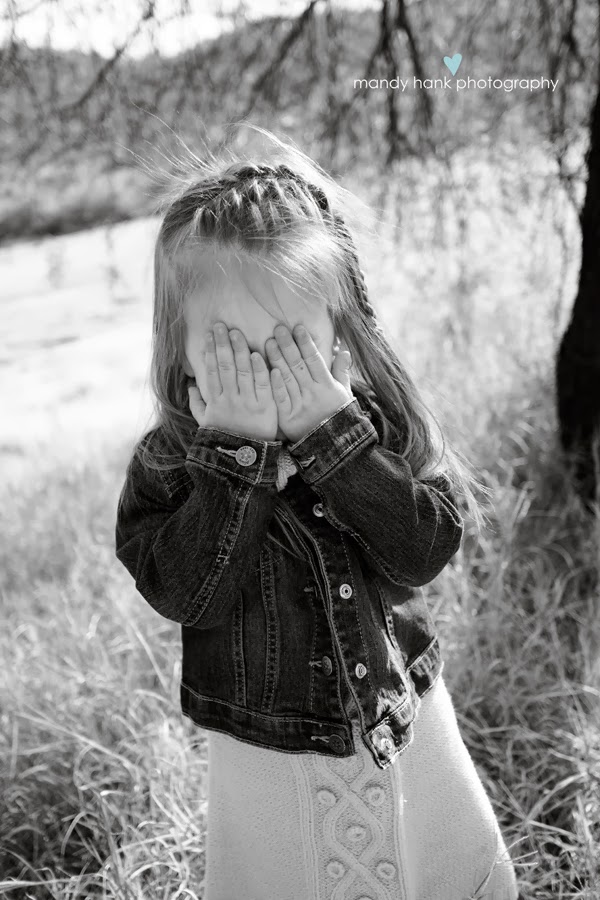 tips for family photos via housebyhoff.com Child covering her eyes with her hands.