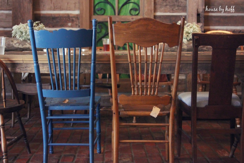 Colourful chairs in the barn at the table.