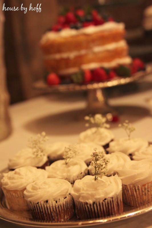 Vanilla cupcakes with a sprig of baby's breath.