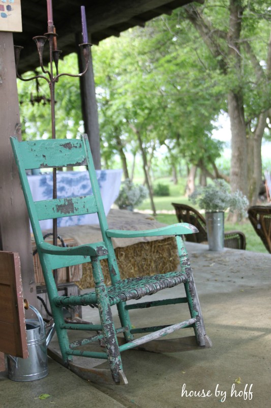 Old weathered rocking chair on porch.