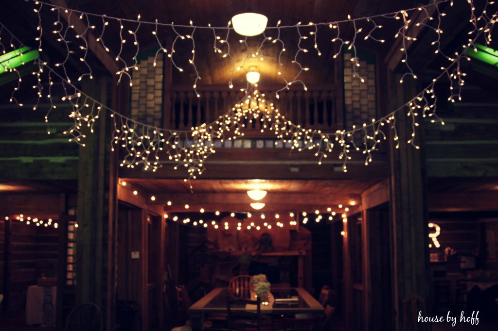 Lovely lights strung up in doorway of barn.