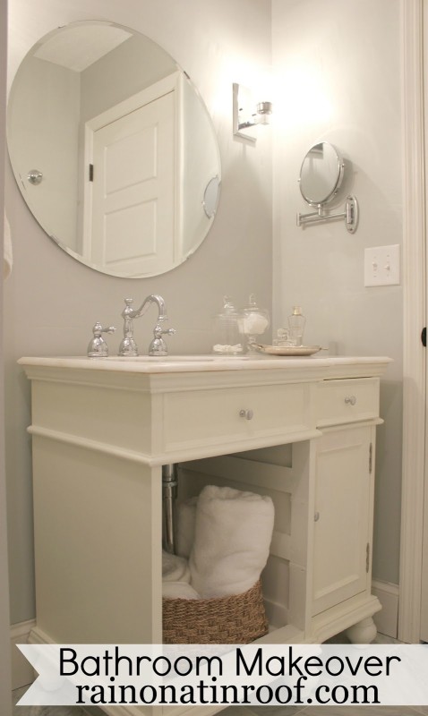 All white bathroom with large mirror above vanity.