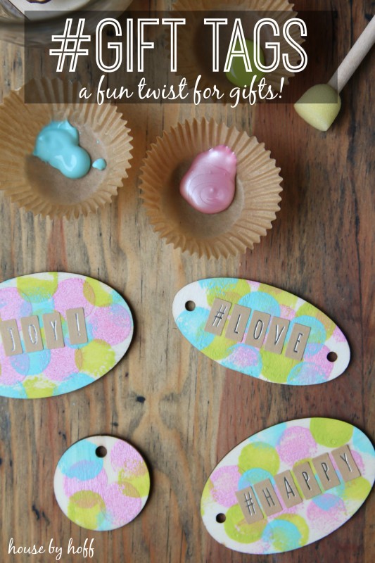 Personalized gift tags on the counter with paint beside them,