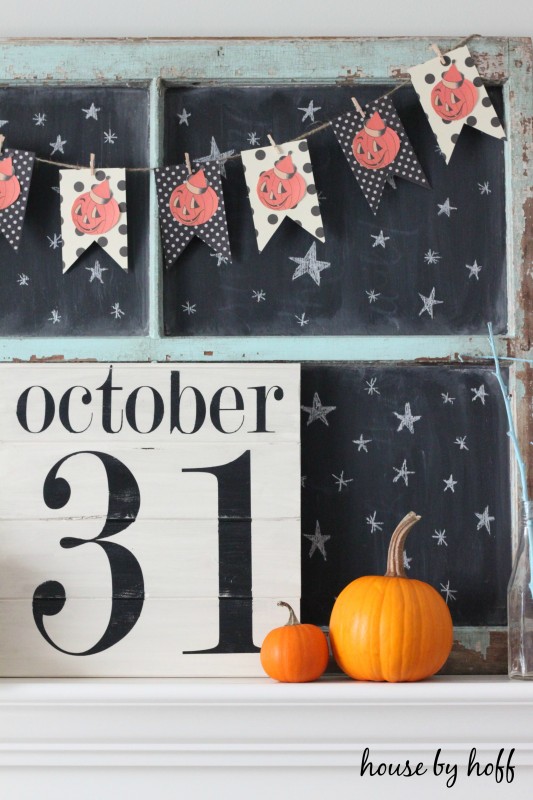 DIY Halloween Sign October 31, with pumpkins and a pumpkin garland on the mantel.