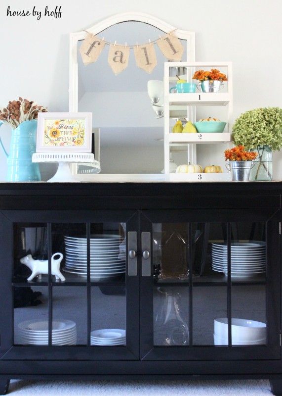 A fall vignette in the dining room on the hutch.