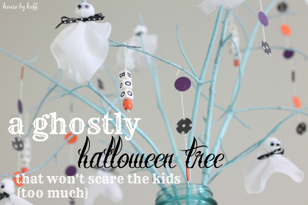 Halloween tree with white ghosts on it.