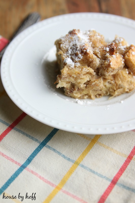 French toast casserole on a plate with a sprinkle of icing sugar on top.