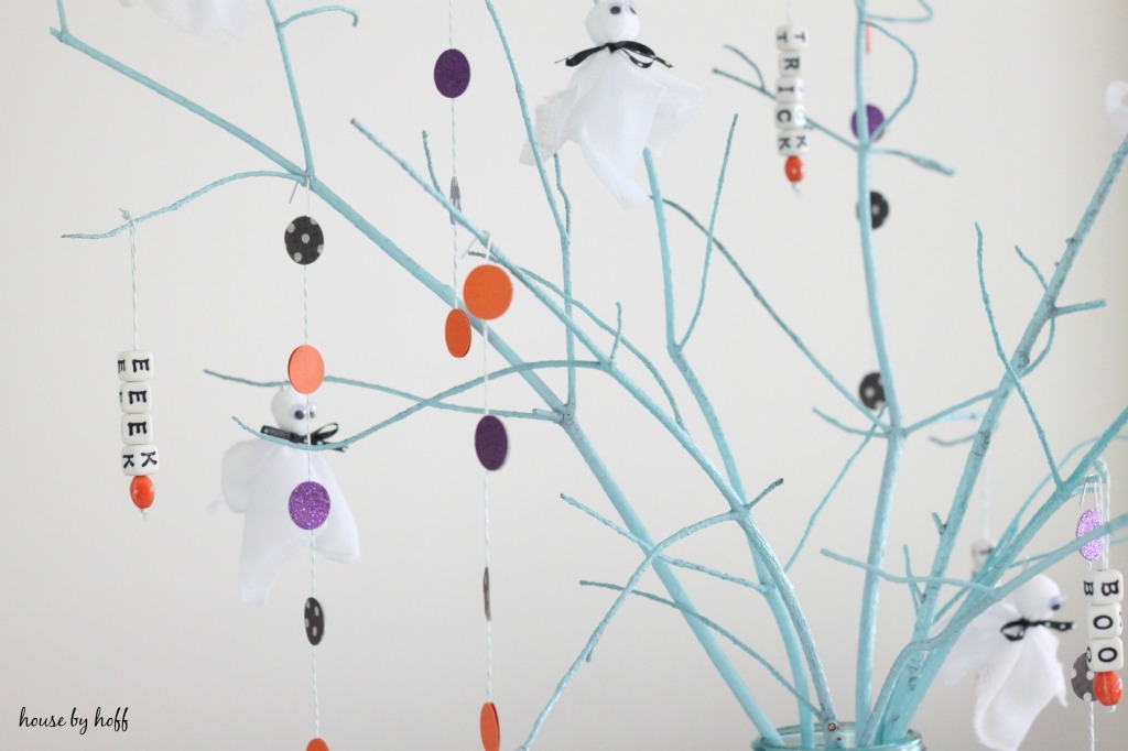 Tree branches with purple, orange dots and ghosts.