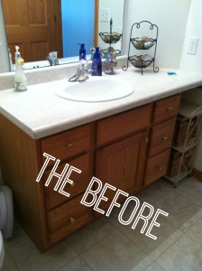 Ugly brown cabinets and grey flooring in before picture.