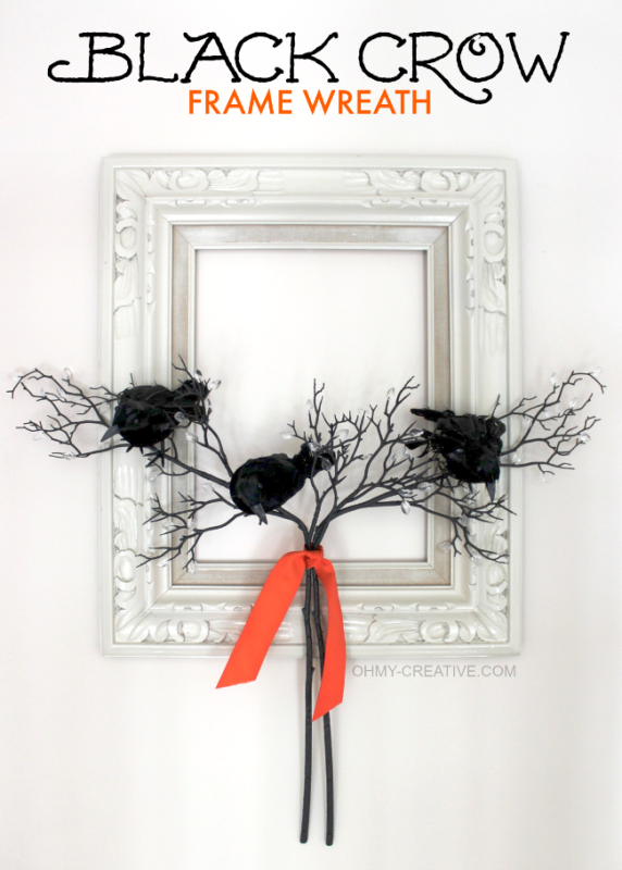 Black crows in front of antique mirror on a branch.