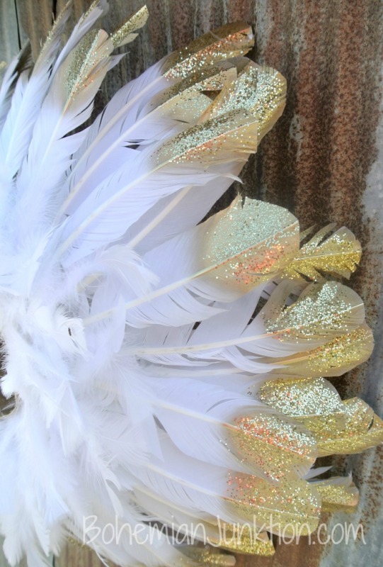 White feathers dipped in glitter gold.
