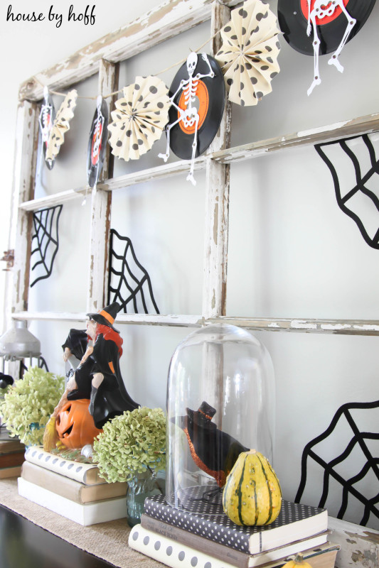 Halloween garland hanging up and witches in cloches.