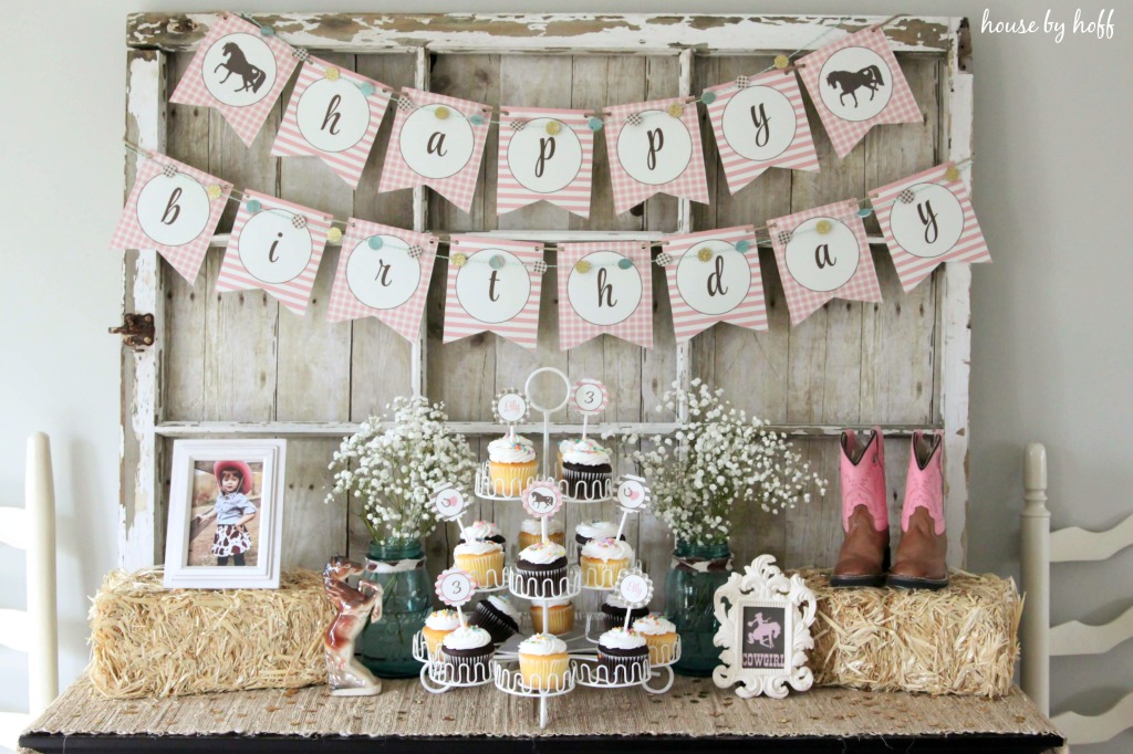 Happy Birthday backdrop and cupcakes.