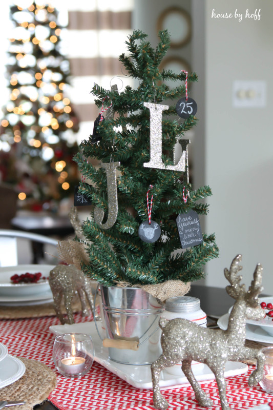 There is a J and a L on the Christmas tree that is on the table.