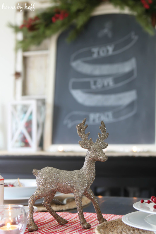 A small sparkly deer is on the table as well.
