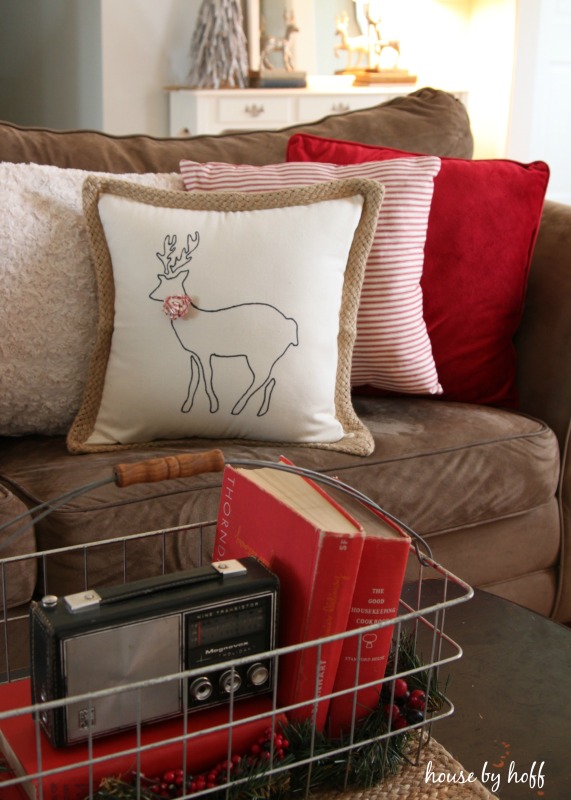 DIY Stenciled Reindeer Pillow on the couch with other pillows.