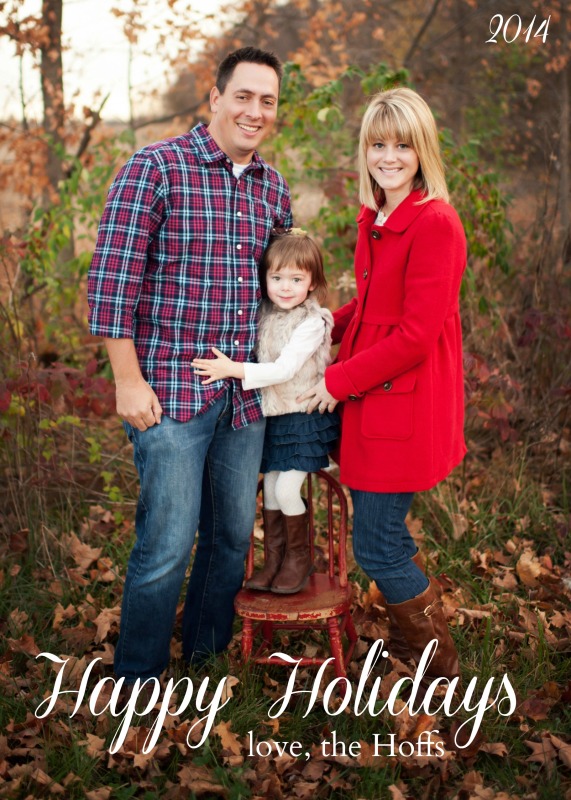 Husband and wife, with a child standing on a chair in the woods picture.