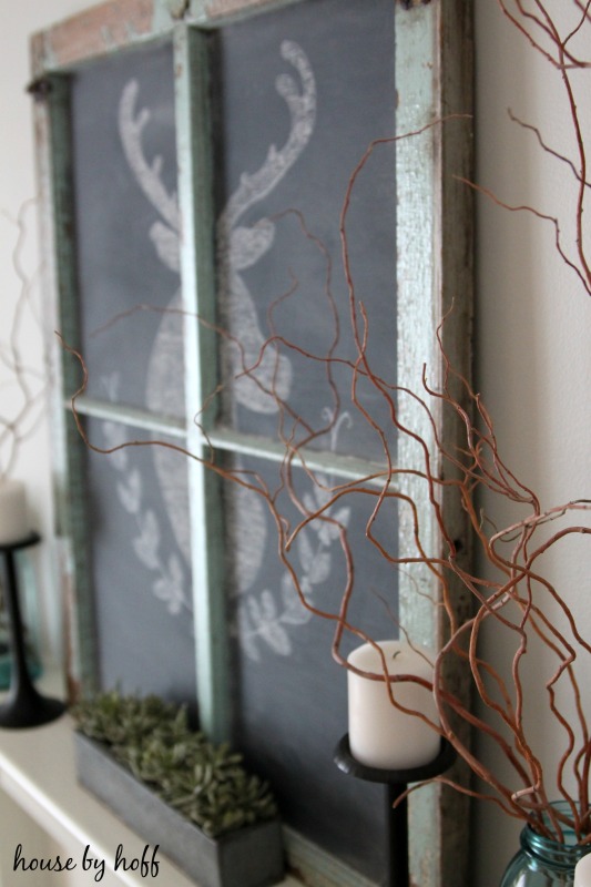 A chalkboard window deer with antlers in chalk.