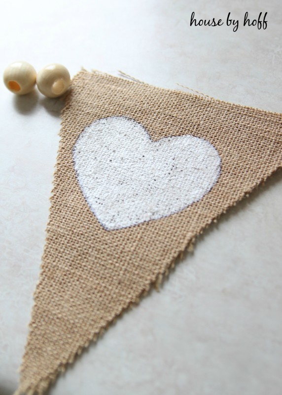 The burlap cut into a triangle with a painted white heart on it.