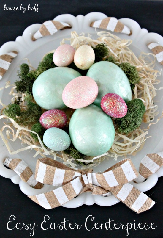 A small display nest with decorated eggs in it.